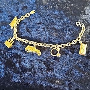 Ladies Charm Bracelet with five charms...size 7 inches  Gold tone